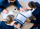 Image of three business people working at meeting