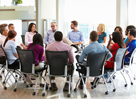 Multi-Cultural Office Staff Sitting Having Meeting Together